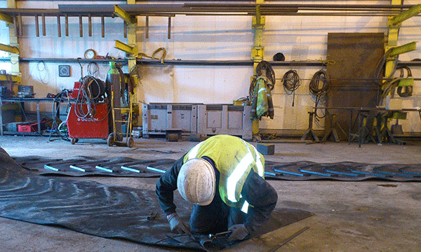 This image shows one of our engineers working on a rubber belt.